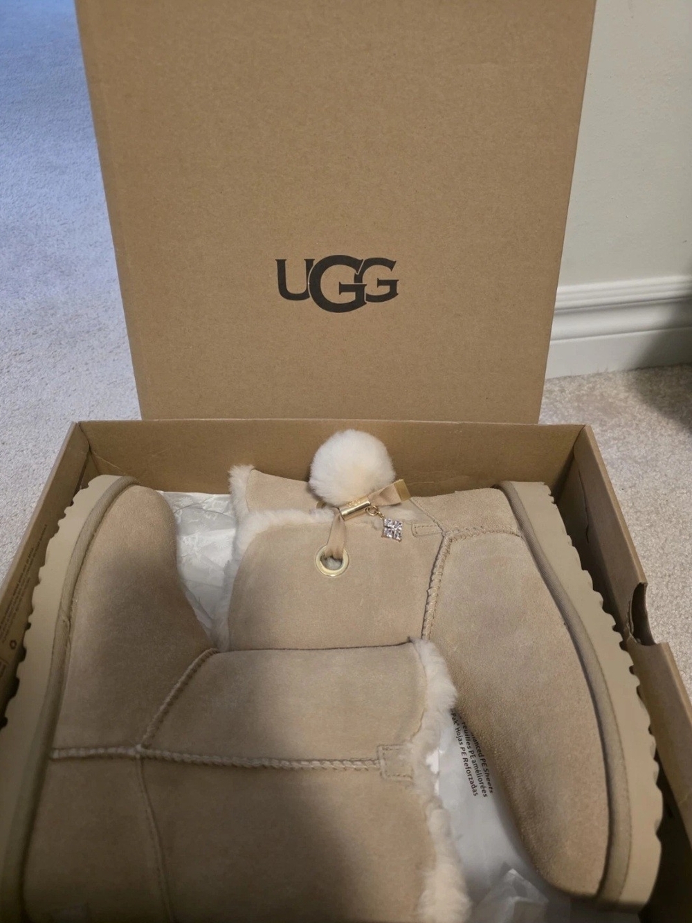 UGG Mini Pom Pom Boot in Chestnut Tan